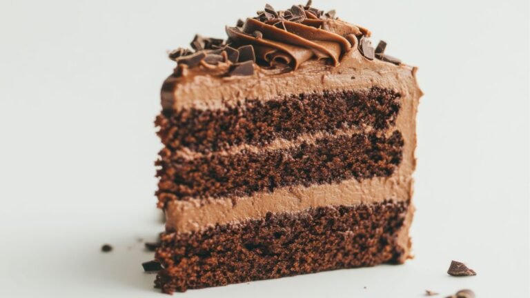 Fatia de bolo de chocolate com recheio de mousse aerada e firme, mostrando a estrutura de corte da receita.