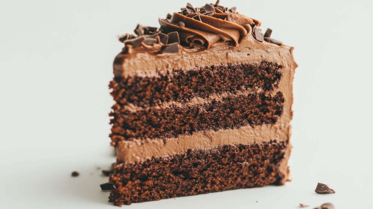 Fatia de bolo de chocolate com recheio de mousse aerada e firme, mostrando a estrutura de corte da receita.