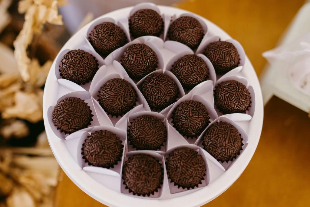 Brigadeiro de chocolate em cima de uma bandeja de festa padronizado com o kit da Bluestar.